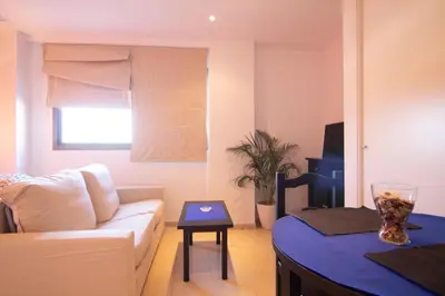 a living room with a couch and a table at Apartamento Racimo El Puerto de Santa Maria in El Puerto de Santa María