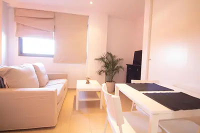 a living room with a couch and a table at Apartamento Racimo El Puerto de Santa Maria in El Puerto de Santa María