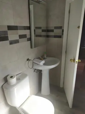 a bathroom with a white sink and a toilet at Hostal Andalucia de Arcos in Arcos de la Frontera