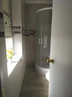 a bathroom with a glass shower and a toilet at Hostal Andalucia de Arcos in Arcos de la Frontera