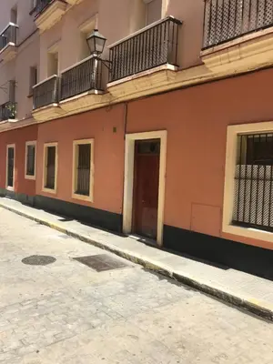 an empty street in front of a building at Rincón en el Mentidero in Cádiz