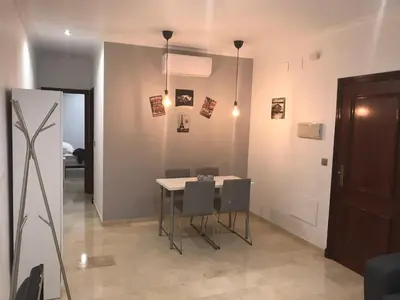 a dining room with a table and chairs at Rincón en el Mentidero in Cádiz