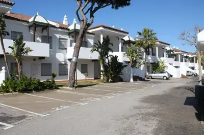 a parking lot in front of a villa at COSTA EL CASTILLO Apartamento con WIFI in Chiclana de la Frontera