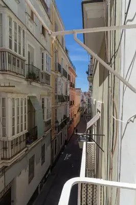 a view of an alley between two buildings at Levante by Gades Gestión in Cádiz