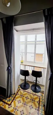 a room with two chairs and a table and a window at Levante by Gades Gestión in Cádiz