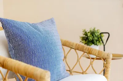 a blue and white pillow sitting on a chair at FARO Family Home by Cadiz4Rentals in Cádiz