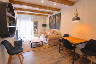 a living room with a couch and a table and chairs at El CONSEJERO de Indias free parking by Cadiz4Rentals in Cádiz