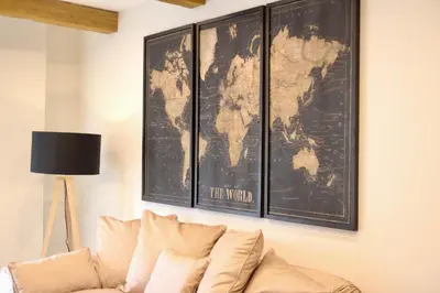 a living room with a couch and a map on the wall at El CONSEJERO de Indias free parking by Cadiz4Rentals in Cádiz