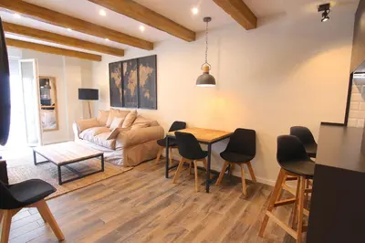 a living room with a couch and a table and chairs at El CONSEJERO de Indias free parking by Cadiz4Rentals in Cádiz