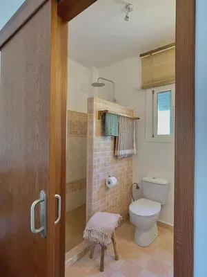 a bathroom with a toilet and a shower in it at bungalow entre mer et montagne in Arcos de la Frontera