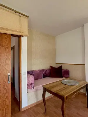 a living room with a couch and a table at bungalow entre mer et montagne in Arcos de la Frontera