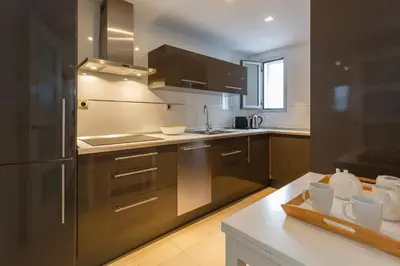 a kitchen with a stainless steel refrigerator and a counter at Calderón De La Barca in Cádiz