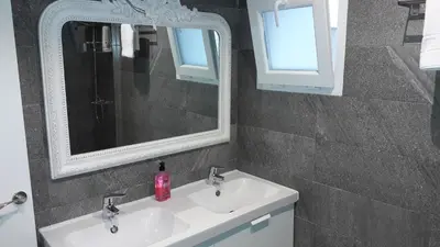 a bathroom with two sinks and a mirror at GUESTING VELAZQUEZ in Cádiz