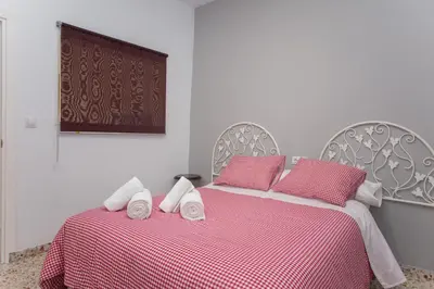 a bedroom with a bed with two towels on it at Multi Apartamentos La Kasbah in Jerez de la Frontera