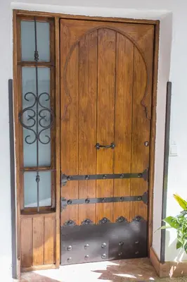 a wooden door with two windows in a room at Multi Apartamentos La Kasbah in Jerez de la Frontera