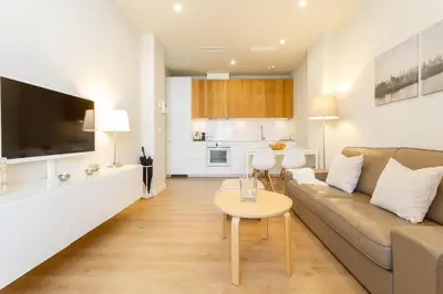 a living room with a couch and a table at Diseño y confort junto a la catedral in Cádiz