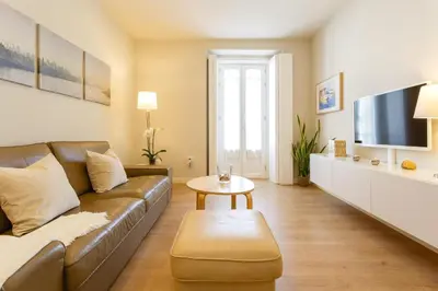 a living room with a couch and a table at Diseño y confort junto a la catedral in Cádiz
