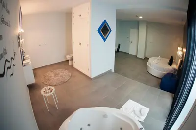 a bathroom with a bath tub and a bath tub at Apartamentos Turísticos La Boutique del Mar in Conil de la Frontera