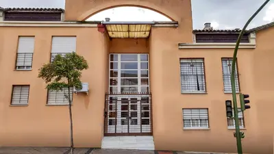 an orange building with a window and a gate at Apartamento Patri in Jerez de la Frontera