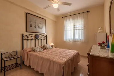 a bedroom with a large bed and a window at Villamar in Cádiz