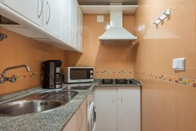a small kitchen with a sink and a microwave at Villamar in Cádiz