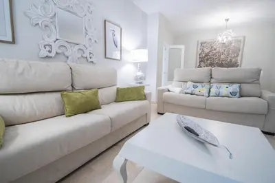 a living room with a couch and a table at Apartamento Sueño de la Caleta in Cádiz