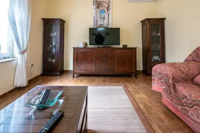 a living room with a coffee table and a tv at Gran Apartamento Avenida 57 in Cádiz