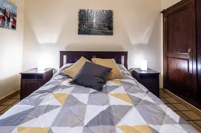 a bedroom with a large bed with two night stands at Gran Apartamento Avenida 57 in Cádiz