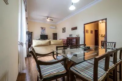 a living room with a glass table and chairs at Gran Apartamento Avenida 57 in Cádiz