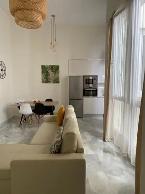 a living room with a couch and a table at Apartamento nuevo en casa tipo palacio in Cádiz