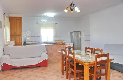 a kitchen and dining room with a table and chairs at Chalet Aroca in Conil de la Frontera