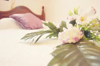 a bed with a bunch of flowers on it at San Nicolás in Algar