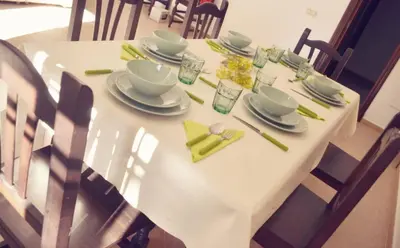 a white table with plates and dishes on it at San Nicolás in Algar
