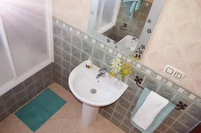 a bathroom with a sink and a mirror at San Nicolás in Algar