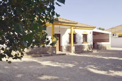a house with a yellow door in front of it at San Nicolás in Algar
