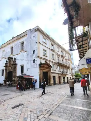 a group of people walking in front of a building at Estudio Boutique Arenal - Cama buhardilla in Jerez de la Frontera