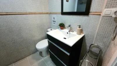a bathroom with a sink and a toilet at Apartamento Levante in Cádiz