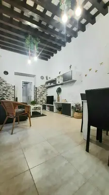 a large living room with a table and chairs at Apartamento Levante in Cádiz