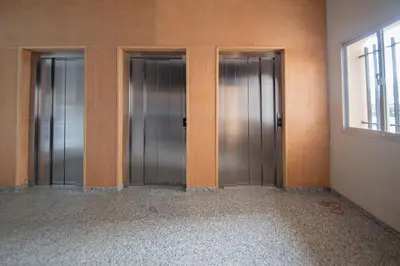 a row of three elevators in a room at Apartamento Malibu Cadiz playa in Cádiz