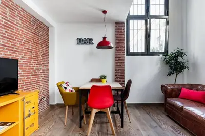 a living room with a table and a couch at SH El Teatro. Dúplex industrial en el Falla. in Cádiz