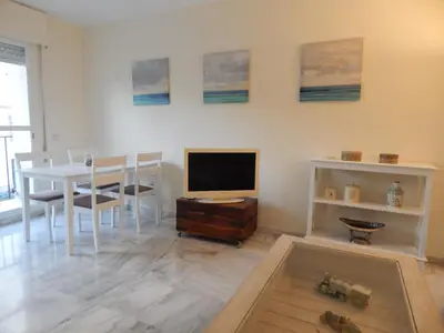 a living room with a table and a television at Apartamento wifi plaza del caballo in Jerez de la Frontera