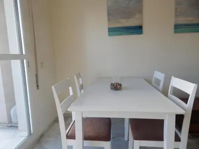 a white dining room table with chairs and a white table at Apartamento wifi plaza del caballo in Jerez de la Frontera
