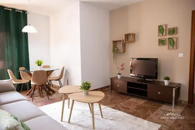 a living room with a couch and a tv and a table at Apartamento Pale Cream MRZ Rentals in Jerez de la Frontera
