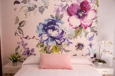a bedroom with a flower mural on the wall at Apartamento Pale Cream MRZ Rentals in Jerez de la Frontera