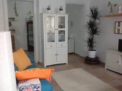 a living room with a white cabinet and a couch at La casa del dibujante in Cádiz