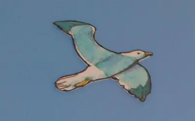 a drawing of a bird flying in the sky at La casa del dibujante in Cádiz