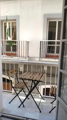 a table and chairs on the balcony of a building at Apartamento El Gaditano Errante in Cádiz
