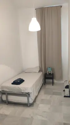 a bedroom with a bed and a pendant light at Apartamento El Gaditano Errante in Cádiz