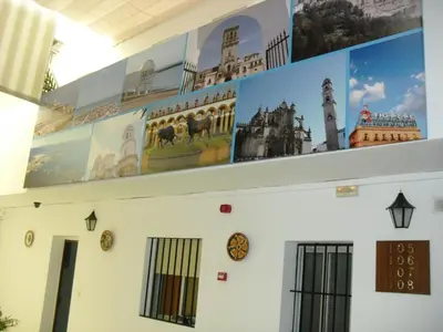 a building with posters on the top of it at El Faisan C&R Hotel in Arcos de la Frontera