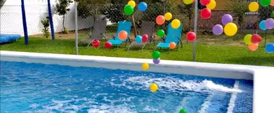 a pool with colorful balls in a yard at Mis Princesas en Casablanca in Chiclana de la Frontera